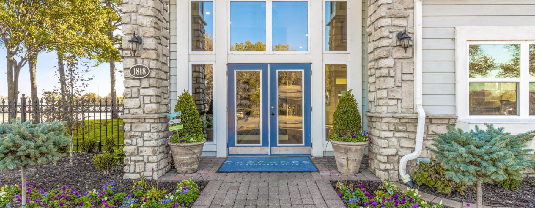a entrance with a brick walkway and a blue door