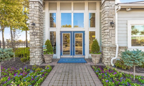 a entrance with a brick walkway and a blue door
